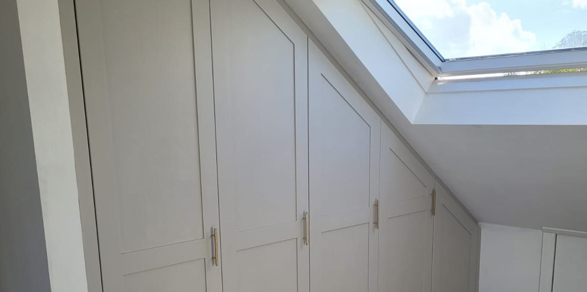 A Sleek loft eaves storage cabinet in a Surrey Home