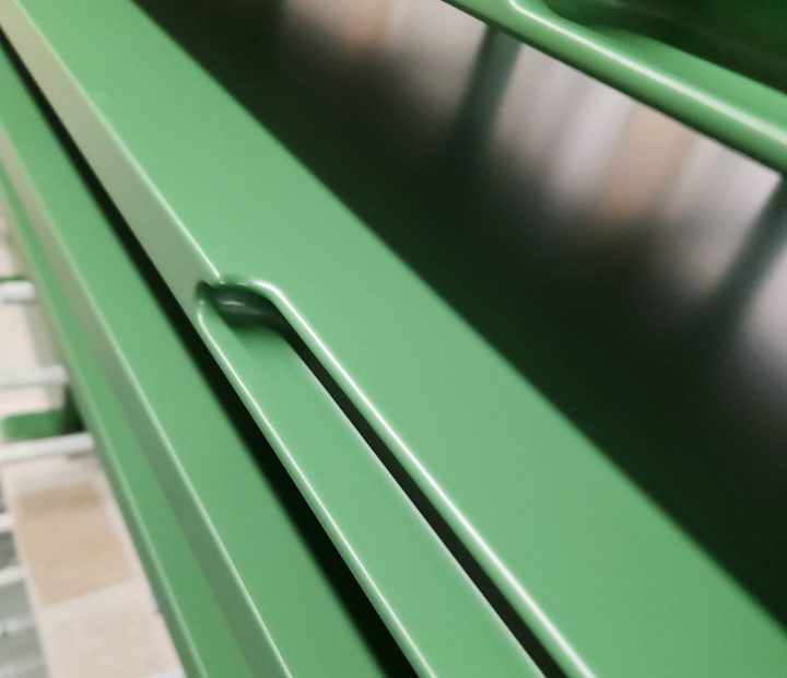 Close-up detail of a bespoke spray-painted cabinet handle with smooth satin finish